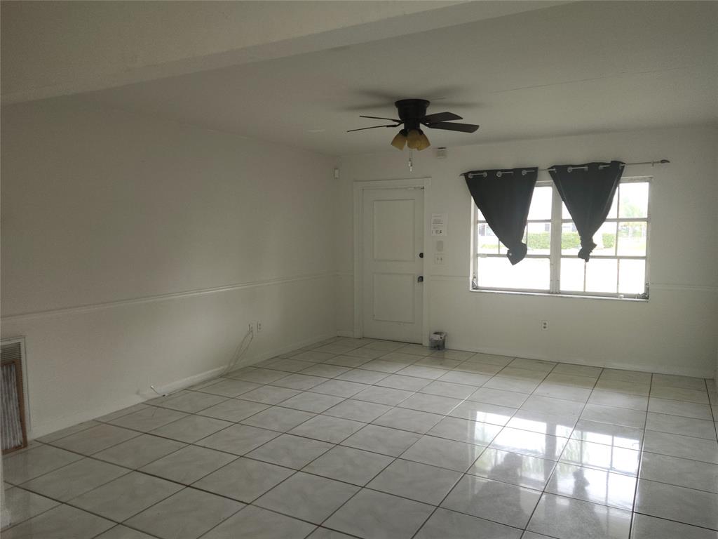 10720 Eureka Street Boca Raton, FL 33428 - Photo 4 of 18 an empty room with windows and fan