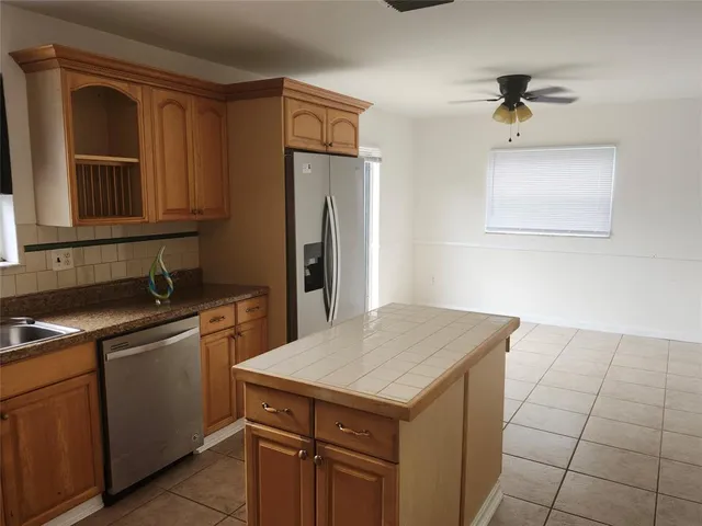 a kitchen with a sink cabinets and appliances