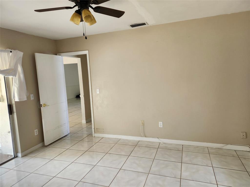 10720 Eureka Street Boca Raton, FL 33428 - Photo 10 of 18 an empty room with windows and cabinet