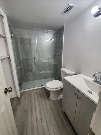 a bathroom with a sink a toilet and a shower