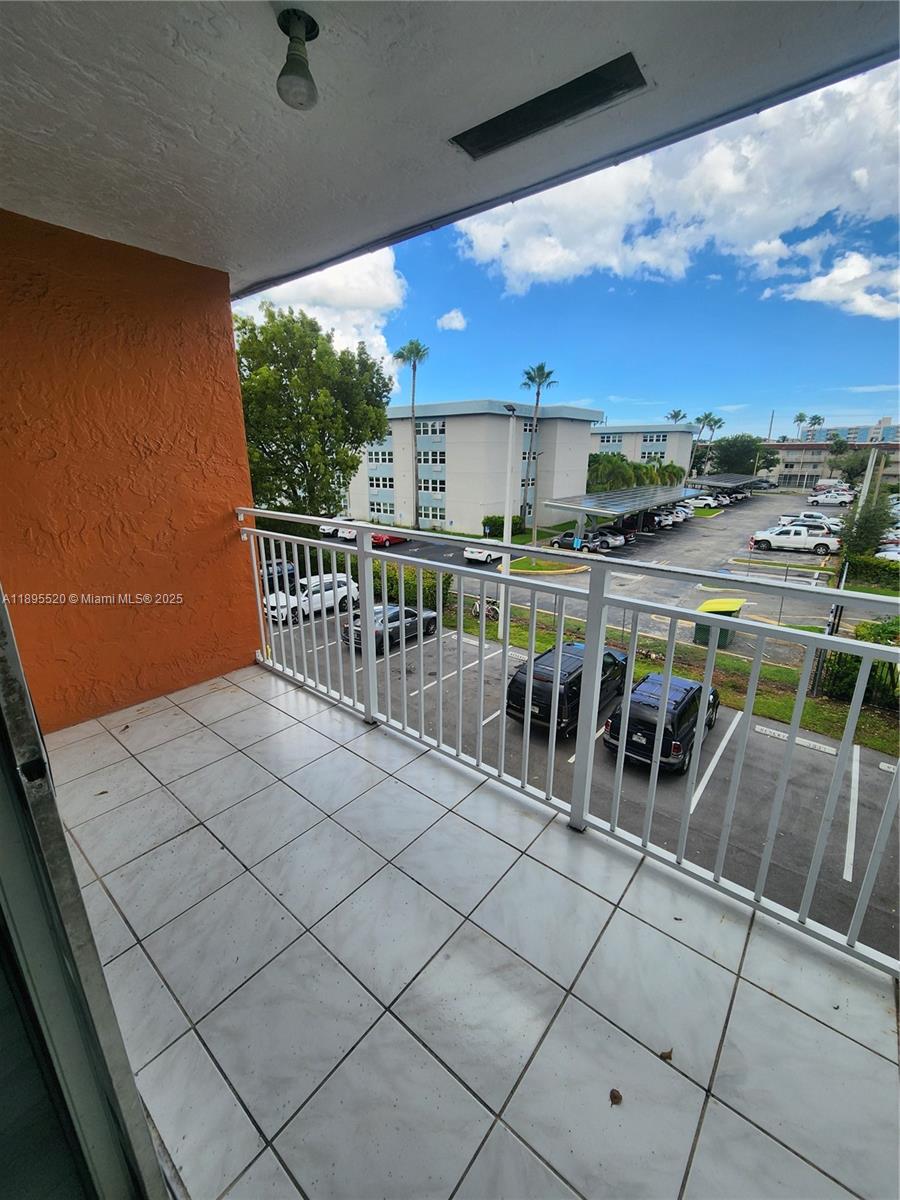11309 Southwest 200th Street, Unit 303C Miami, FL 33157 - Photo 15 of 21 a view of a chairs and table in the terrace
