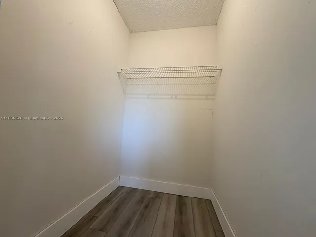 a utility room with a stove and a microwave