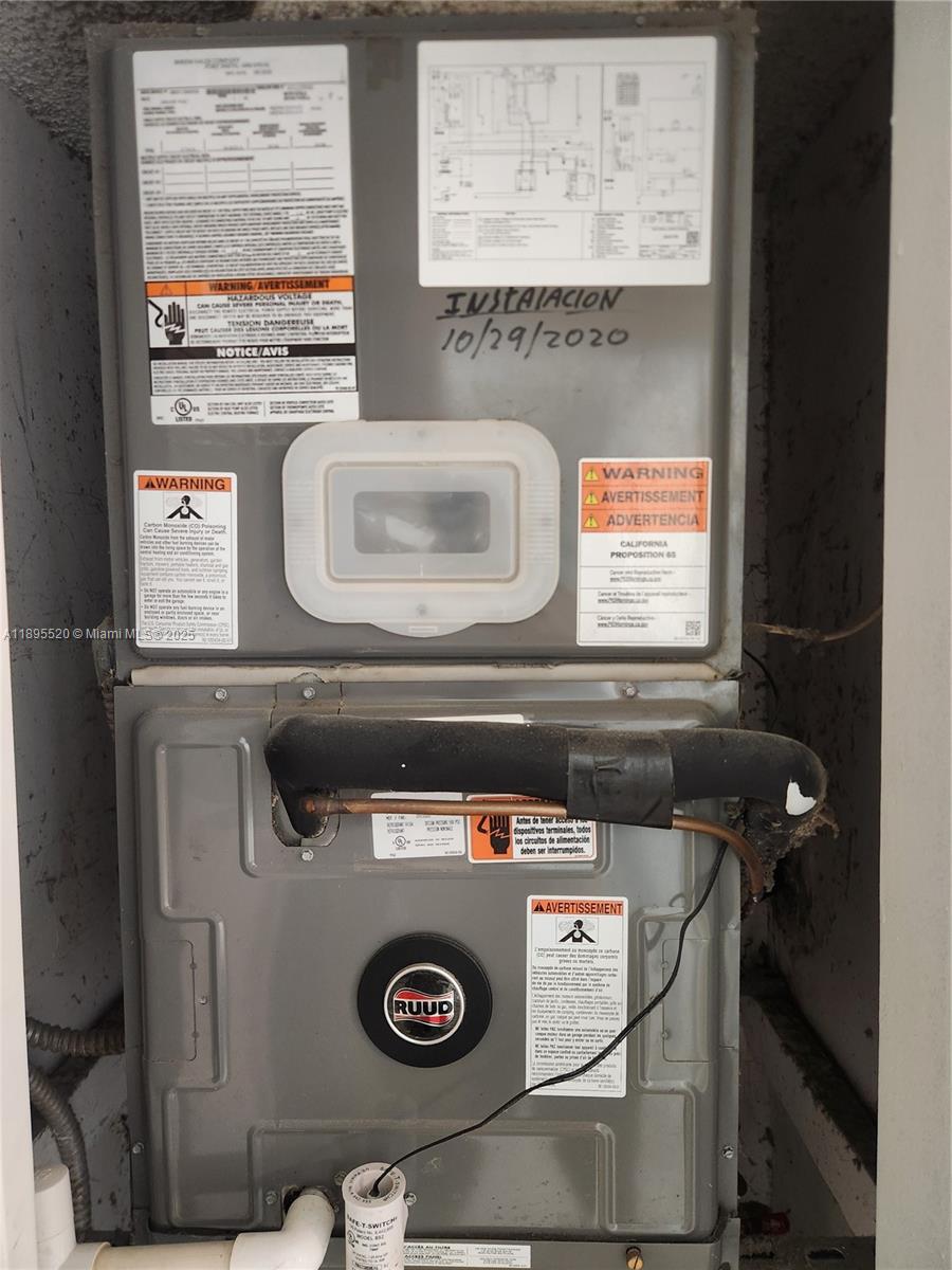 11309 Southwest 200th Street, Unit 303C Miami, FL 33157 - Photo 20 of 21 a utility room with a stove and a microwave