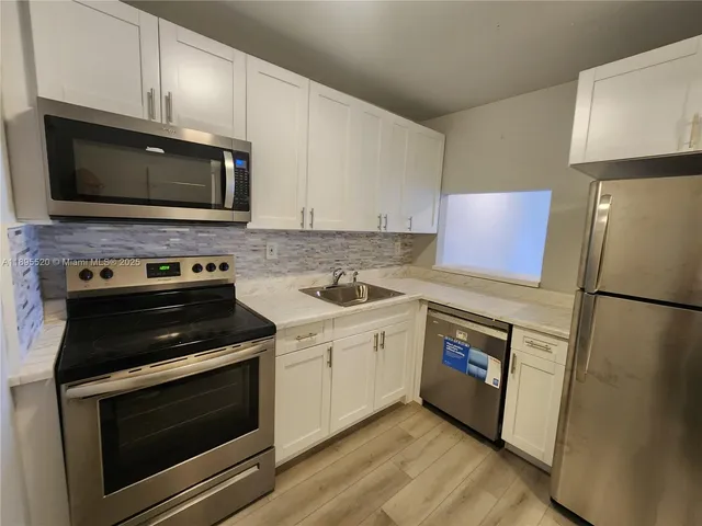 a kitchen with a stove and a microwave