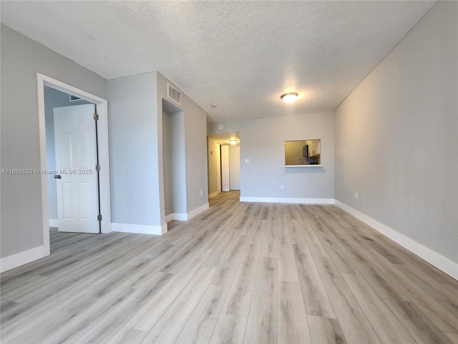 11309 Southwest 200th Street, Unit 303C Miami, FL 33157 - Photo 4 of 21 wooden floor in an empty room with a window