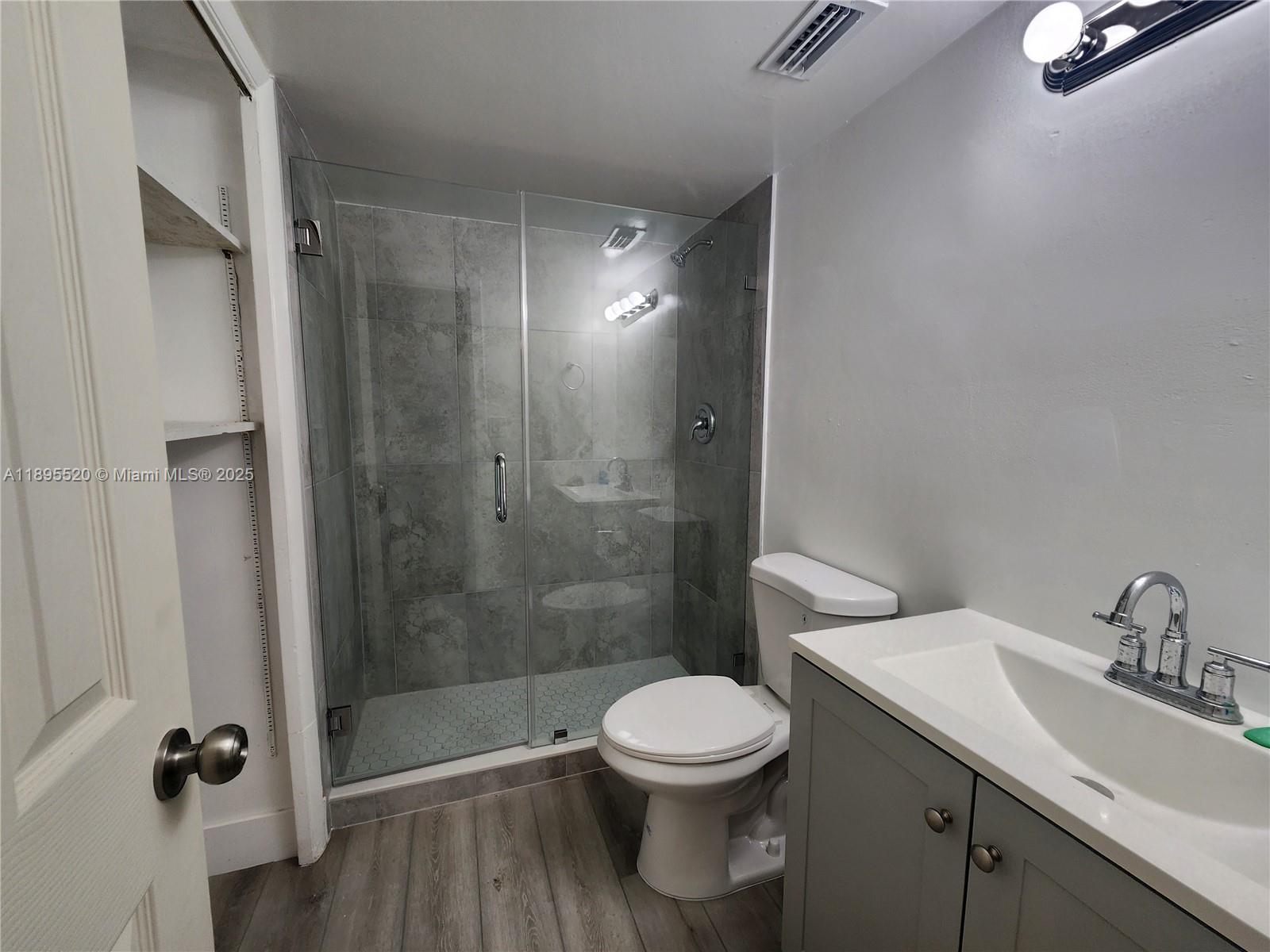 11309 Southwest 200th Street, Unit 303C Miami, FL 33157 - Photo 6 of 21 a bathroom with a shower a toilet and a sink