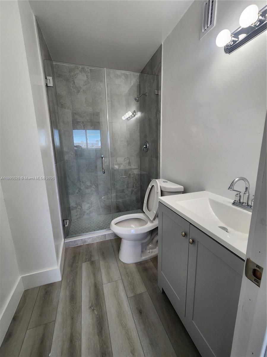 11309 Southwest 200th Street, Unit 303C Miami, FL 33157 - Photo 8 of 21 a bathroom with a sink a toilet a mirror and shower