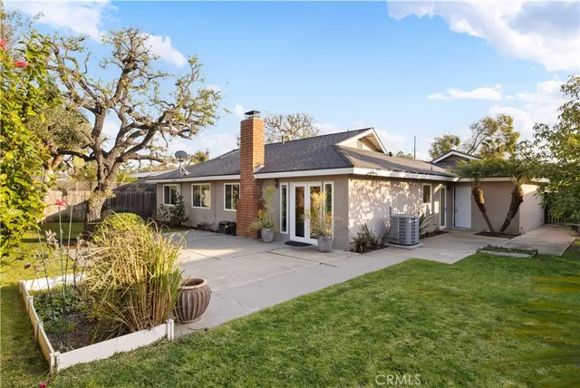 a front view of a house with a yard glass top table and chairs