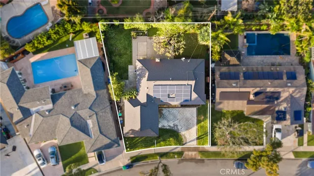 an aerial view of a houses with yard