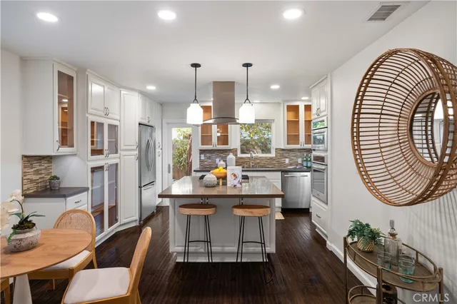 a view of a kitchen with dining table and chairs