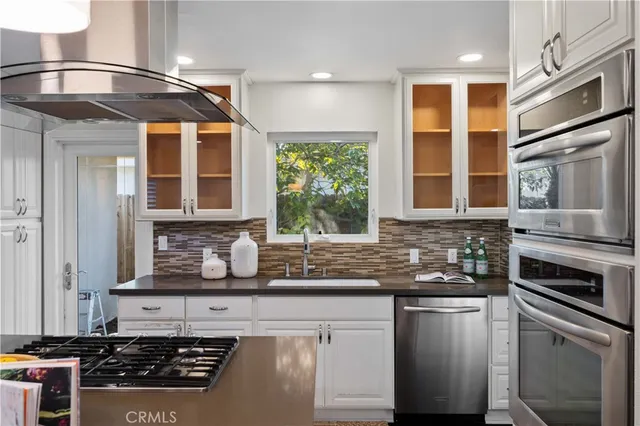 a kitchen with stainless steel appliances granite countertop a stove and a sink