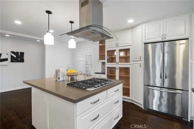 a kitchen with stainless steel appliances granite countertop a refrigerator a stove and a wooden floors