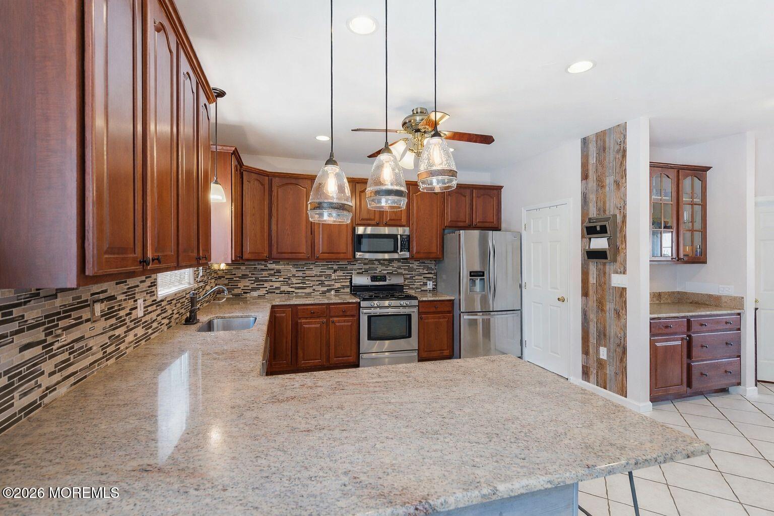 9 Kindling Way Jackson, NJ 08527 - Photo 13 of 33 a large kitchen with stainless steel appliances granite countertop a stove and a sink with granite countertops