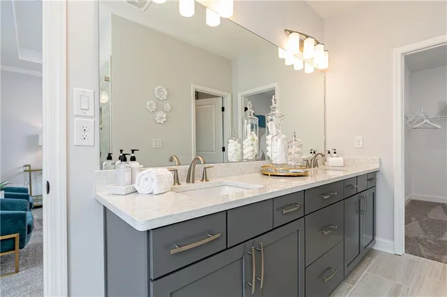 a spacious bathroom with a granite countertop sink a toilet and shower curtain