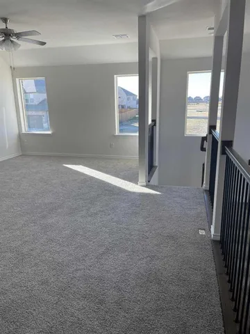 an empty room with windows and closet