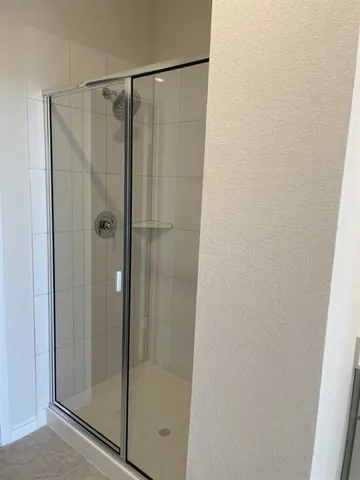 a bathroom with a glass shower door