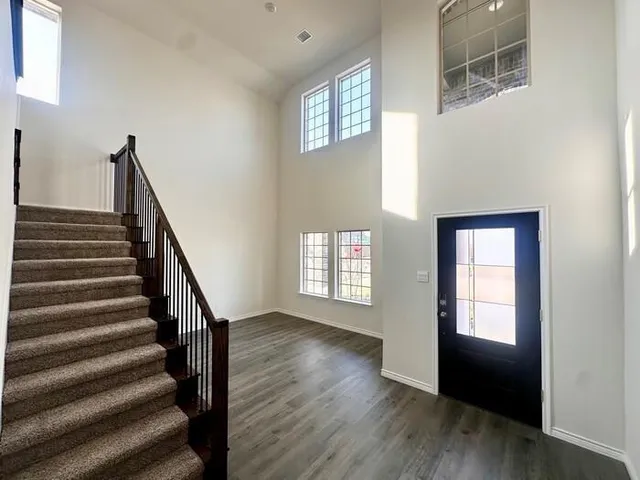 a view of an entryway with wooden floor and stairs