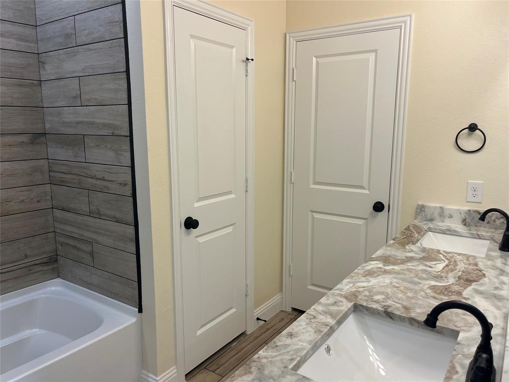 5332 Booker T Street Fort Worth, TX 76105 - Photo 9 of 18 a bedroom with a bed and a dresser