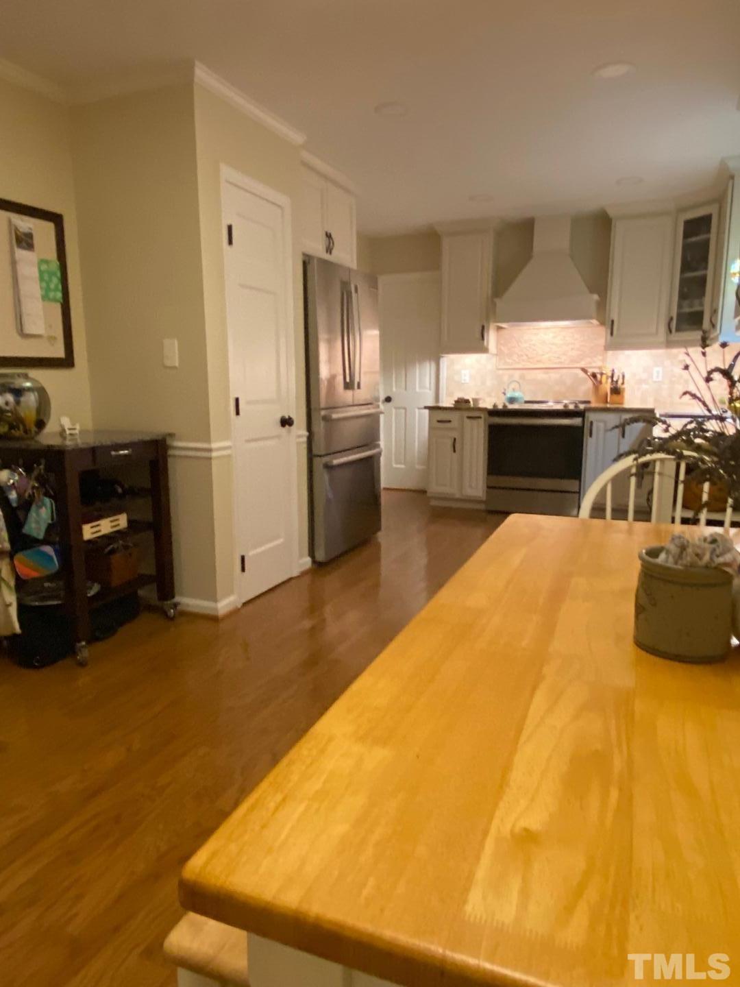 6105 Iris Drive Raleigh, NC 27612 - Photo 3 of 13 a kitchen with stainless steel appliances kitchen island sink refrigerator and stove