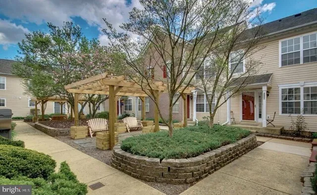 a view of a house with a backyard and sitting area