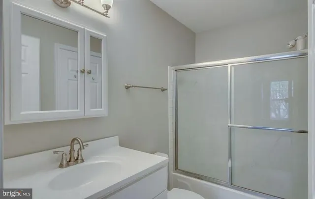 a bathroom with a sink and mirror