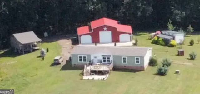 a aerial view of a house with a yard