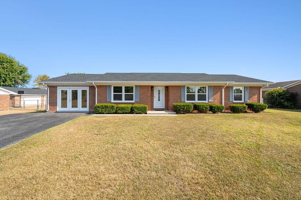 210 Gillen Drive Sparta, TN 38583 - Photo 2 of 16 a front view of a house with a yard and potted plants