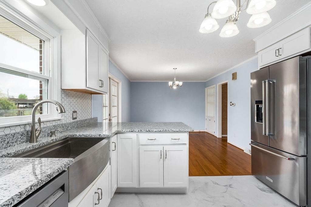 210 Gillen Drive Sparta, TN 38583 - Photo 3 of 16 a kitchen with stainless steel appliances granite countertop a sink a stove a refrigerator and island