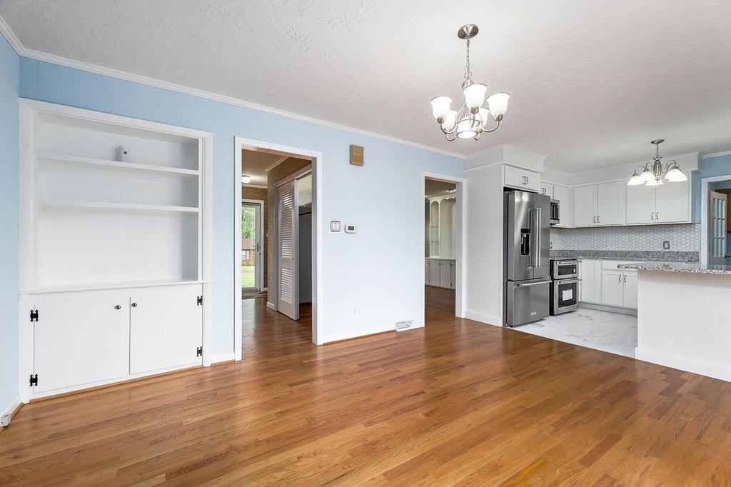 210 Gillen Drive Sparta, TN 38583 - Photo 5 of 16 a view of a kitchen with refrigerator and wooden floor