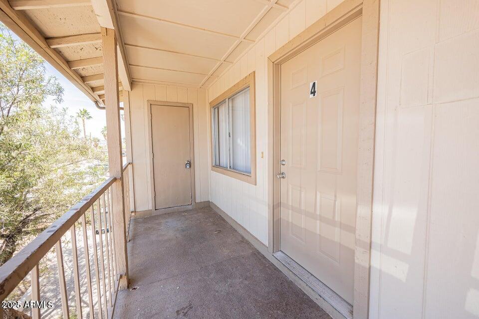127 South Outpost Road, Unit 4 Apache Junction, AZ 85119 - Photo 1 of 8 a view of a porch with wooden floor and windows