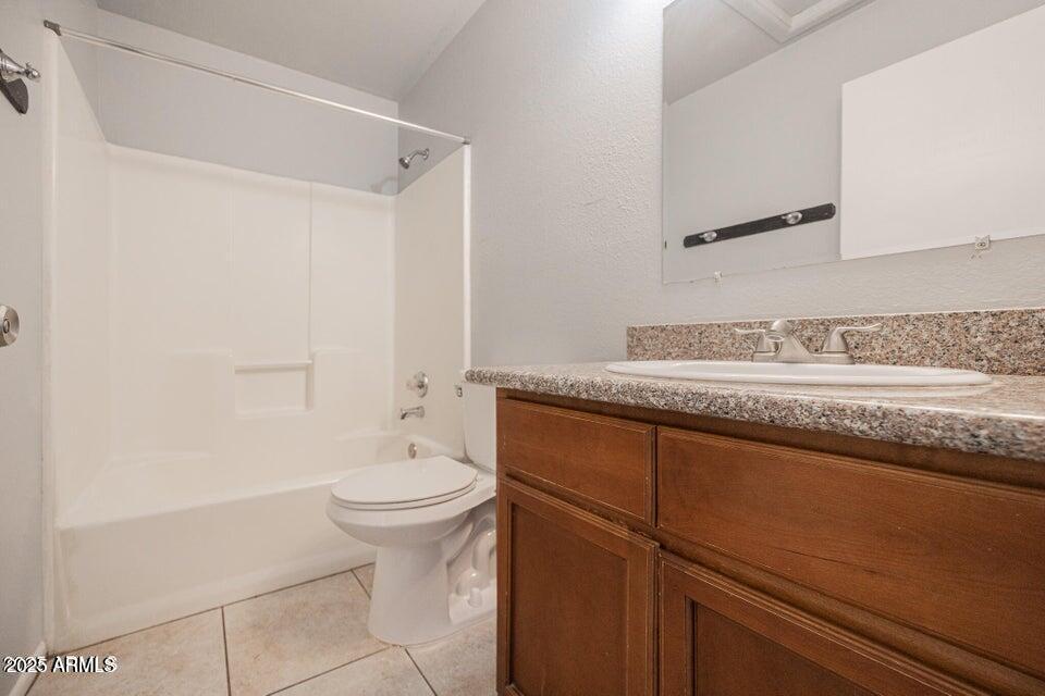 127 South Outpost Road, Unit 4 Apache Junction, AZ 85119 - Photo 6 of 8 a bathroom with a granite countertop sink a toilet and a mirror