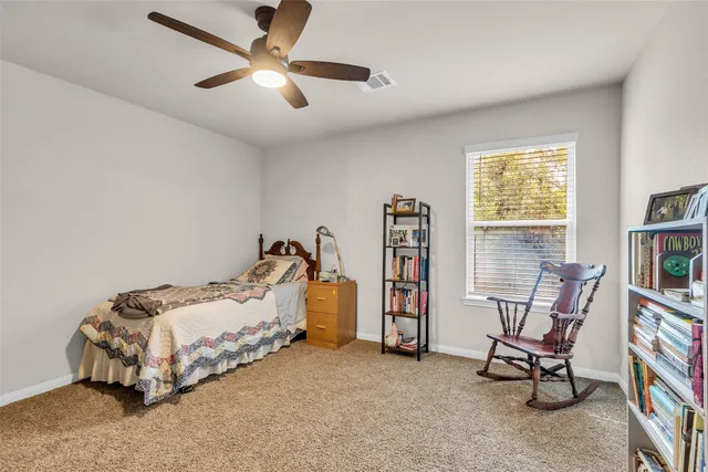 a bed room with a bed and a chair