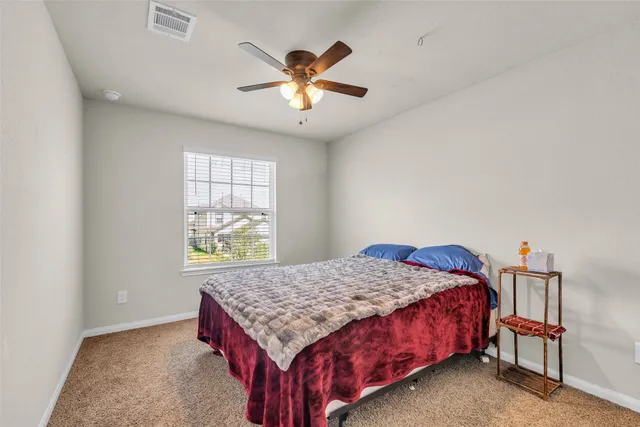 a bedroom with a bed and window