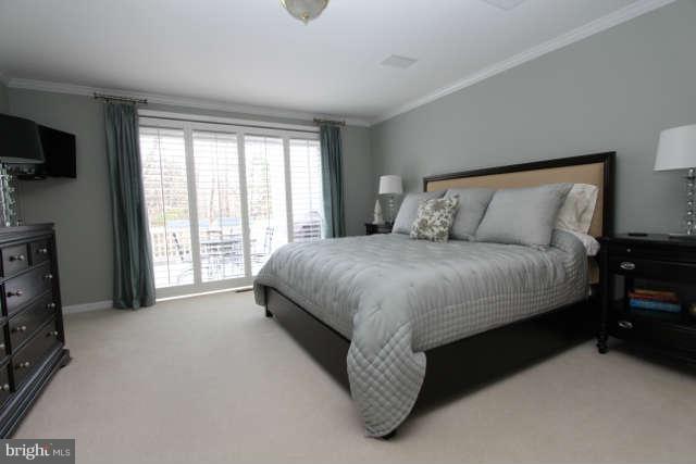 1330 Wedgewood Manor Way Reston, VA 20194 - Photo 11 of 30 a spacious bedroom with a bed and a flat tv screen on the dresser