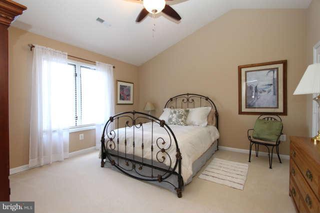 1330 Wedgewood Manor Way Reston, VA 20194 - Photo 14 of 30 a bedroom with a bed and a chandelier