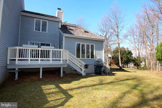 1330 Wedgewood Manor Way Reston, VA 20194 - Photo 26 of 30 a view of a house with a wooden deck and a yard