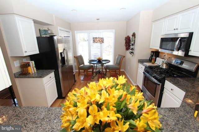1330 Wedgewood Manor Way Reston, VA 20194 - Photo 4 of 30 a living room with stainless steel appliances furniture a rug and a window