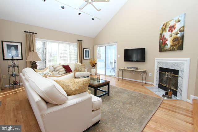 1330 Wedgewood Manor Way Reston, VA 20194 - Photo 8 of 30 a living room with furniture a flat screen tv and a fireplace