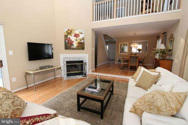 1330 Wedgewood Manor Way Reston, VA 20194 - Photo 10 of 30 a living room with furniture a flat screen tv and a fireplace