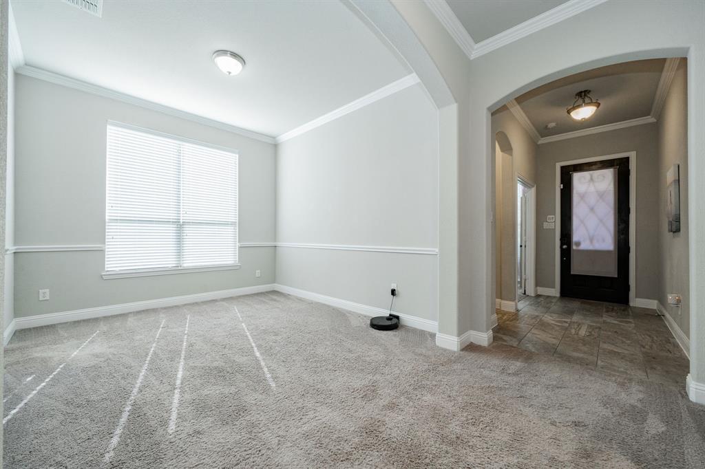593 Spruce Trail Forney, TX 75126 - Photo 18 of 40 Entryway with crown molding, light colored carpet, and arched walkways