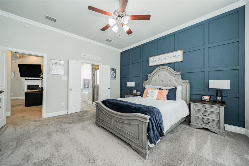 593 Spruce Trail Forney, TX 75126 - Photo 20 of 40 Bedroom featuring ornamental molding, light carpet, ceiling fan, ensuite bathroom, and a decorative wall