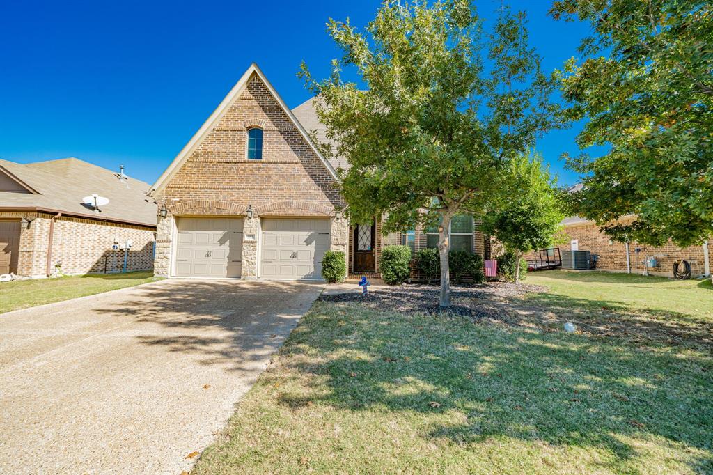 593 Spruce Trail Forney, TX 75126 - Photo 2 of 40 View of front of house featuring a front lawn, driveway, a garage, brick siding, and stone siding