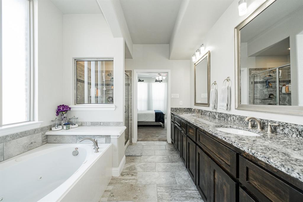 593 Spruce Trail Forney, TX 75126 - Photo 23 of 40 Ensuite bathroom with a tub with jets, double vanity, a shower stall, and a ceiling fan