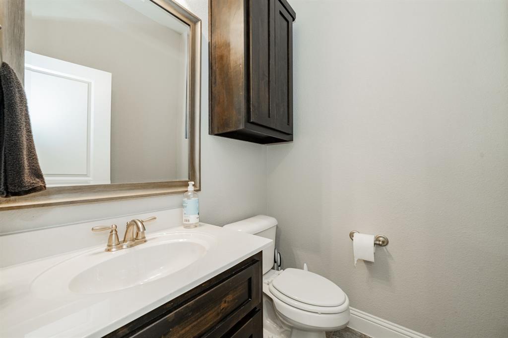 593 Spruce Trail Forney, TX 75126 - Photo 25 of 40 Half bathroom featuring vanity and toilet