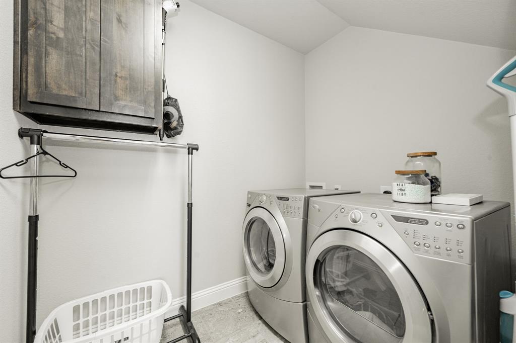 593 Spruce Trail Forney, TX 75126 - Photo 26 of 40 Laundry room with washing machine and dryer and cabinet space