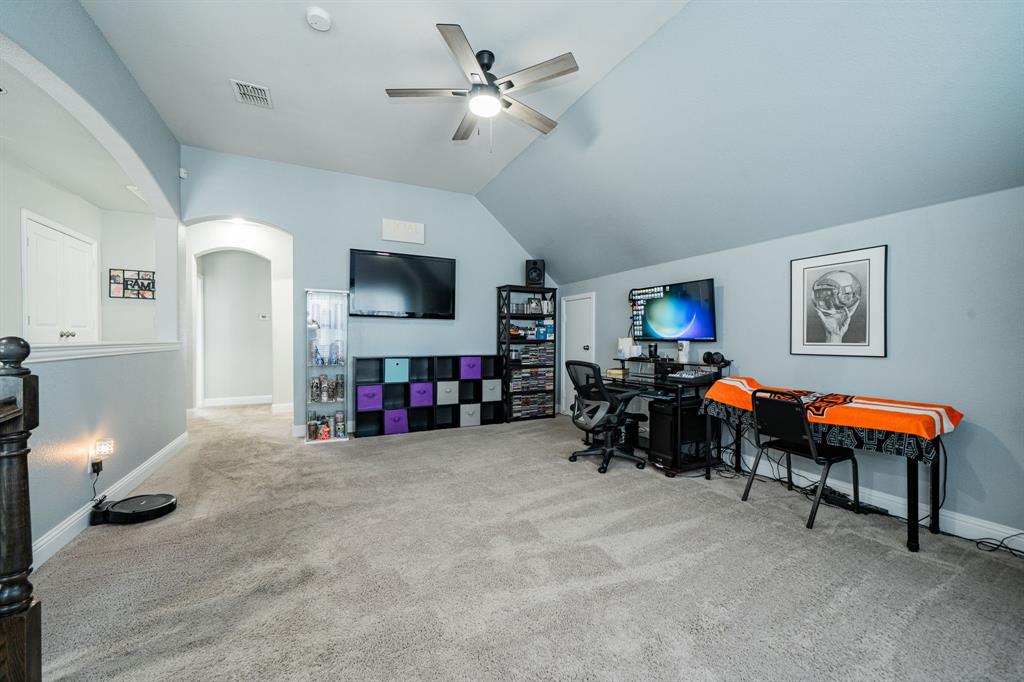 593 Spruce Trail Forney, TX 75126 - Photo 29 of 40 Office with arched walkways, carpet flooring, a ceiling fan, and lofted ceiling