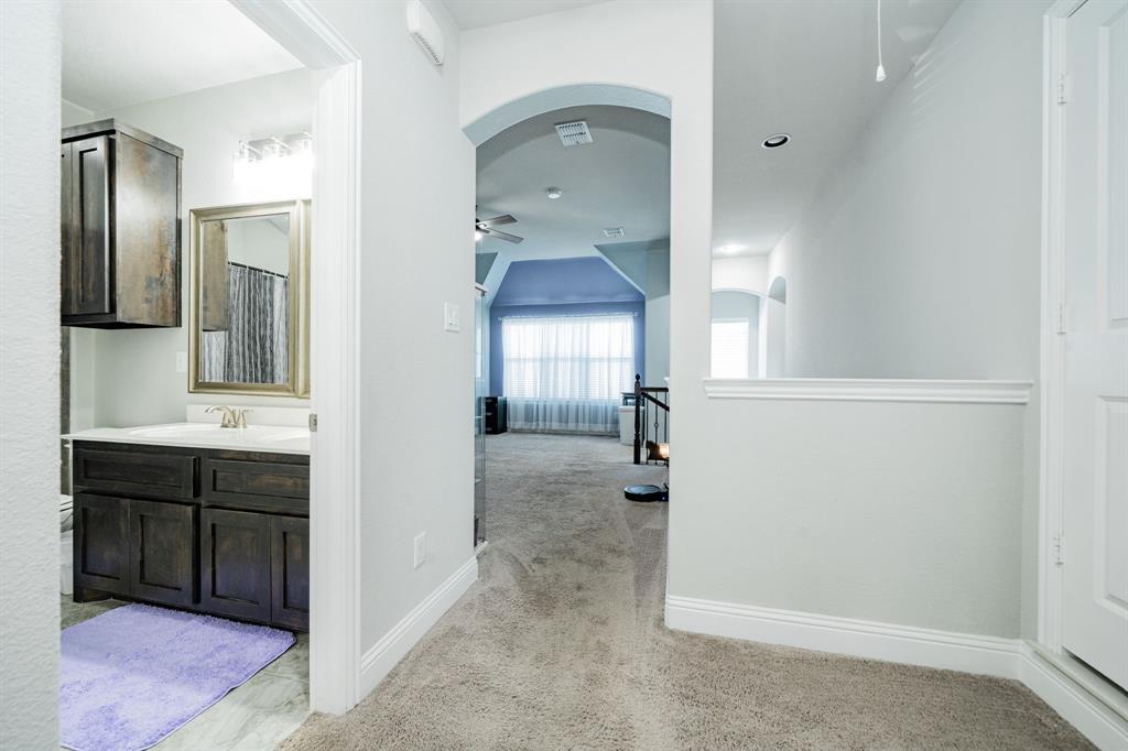 593 Spruce Trail Forney, TX 75126 - Photo 33 of 40 Hall with light colored carpet, arched walkways, and recessed lighting