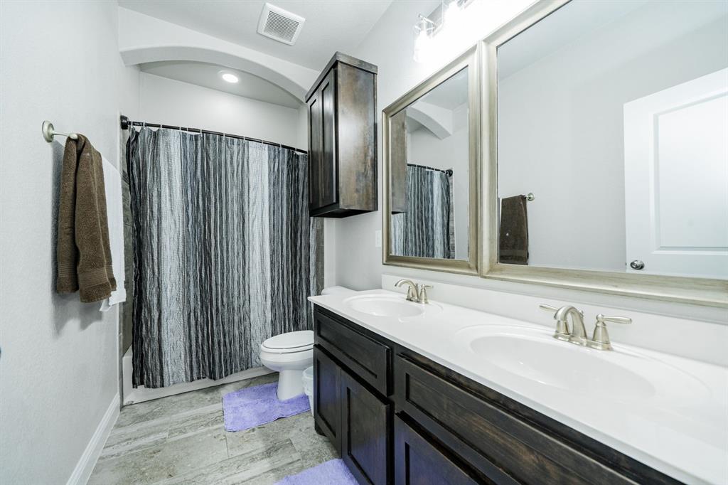 593 Spruce Trail Forney, TX 75126 - Photo 34 of 40 Bathroom featuring double vanity, light wood finished floors, and shower / bath combo