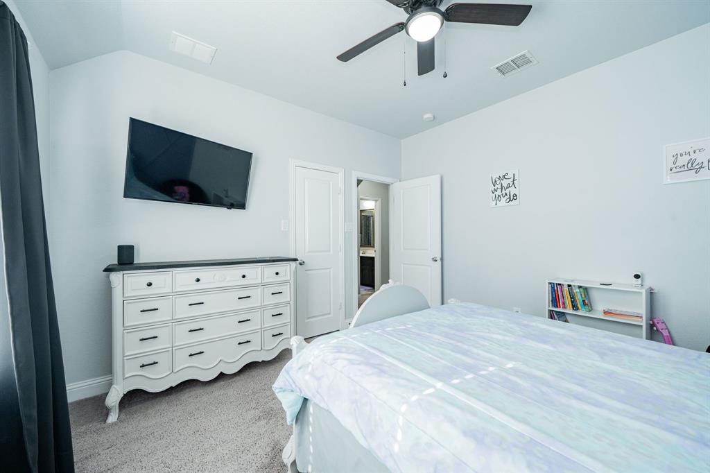 593 Spruce Trail Forney, TX 75126 - Photo 37 of 40 Bedroom with light colored carpet and a ceiling fan