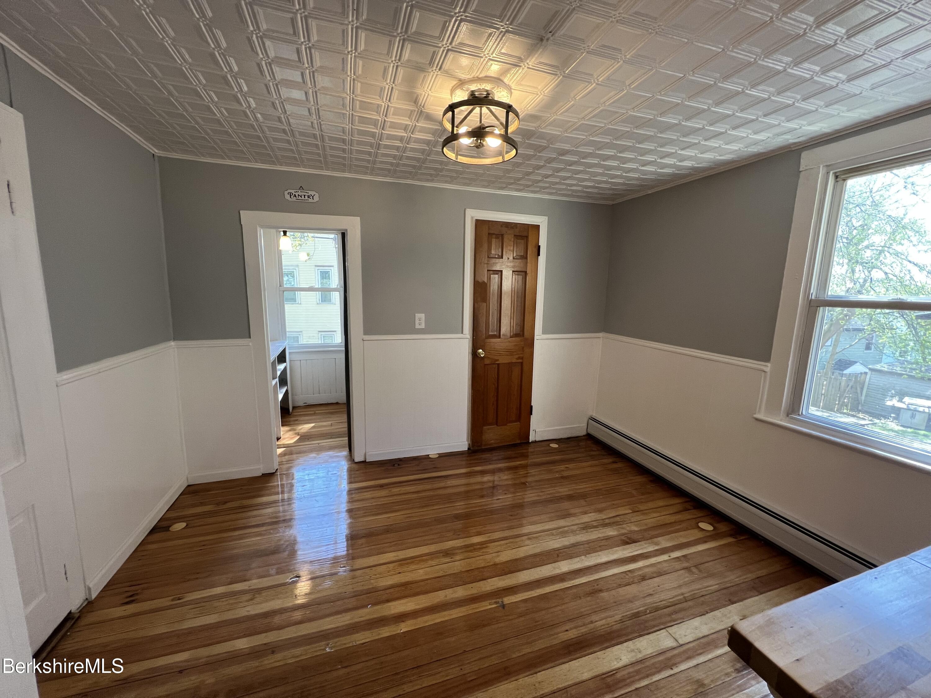 71 Howard Street Pittsfield, MA 01201 - Photo 15 of 42 a view of an empty room with wooden floor and a window